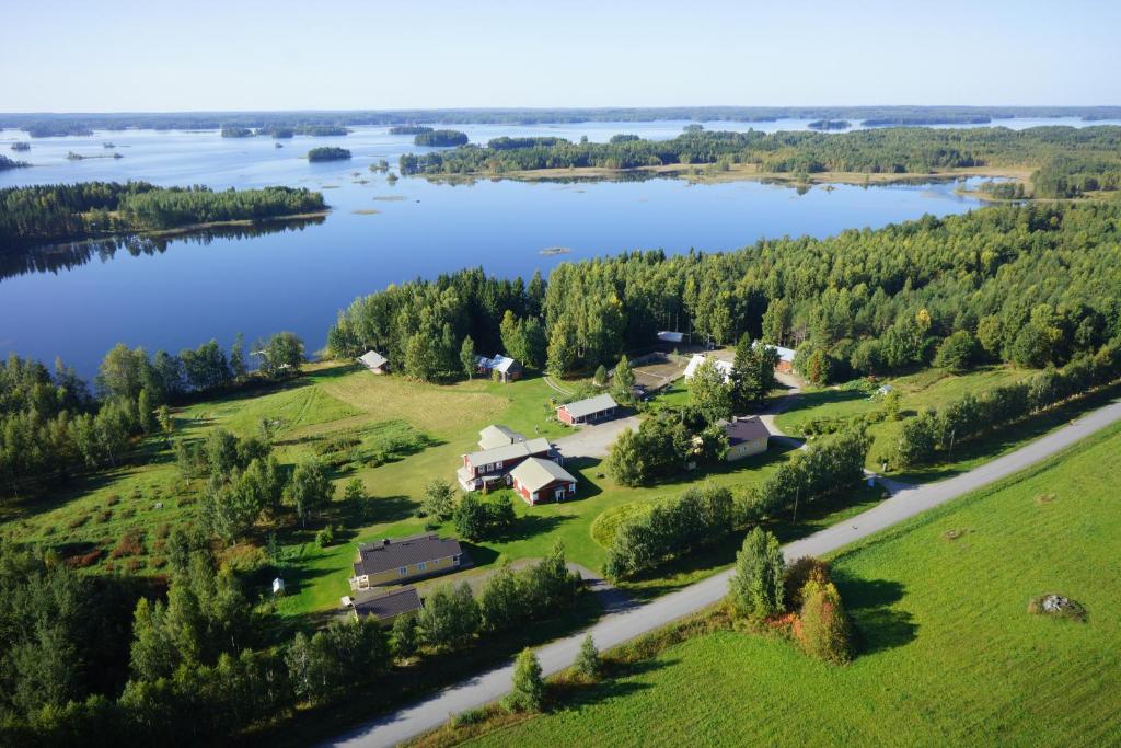an aerial view of a farm on a lake at Karjalan Helmi in Tolosenmäki