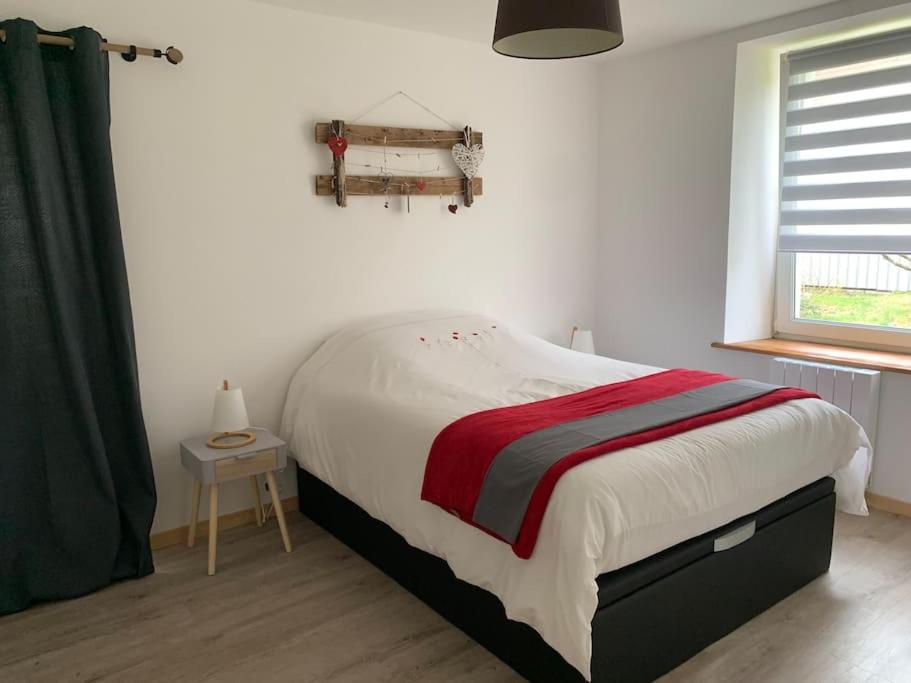 a bedroom with a large bed and a window at Appartement 2/4 personnes in Bussang