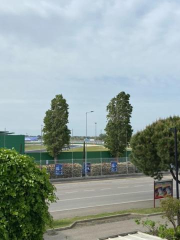 a street with trees and a fence on the side of a road at Appena fuori in Misano Adriatico