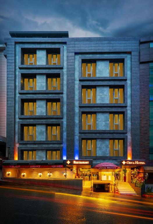 an apartment building with a building at night at Orya Hotel in Istanbul