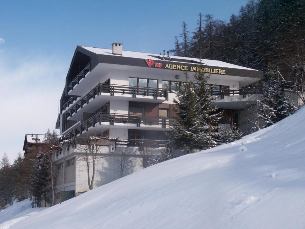 a building on top of a snow covered slope at Fontanettaz V 015 - MOUNTAIN apartment 6 pers in Veysonnaz