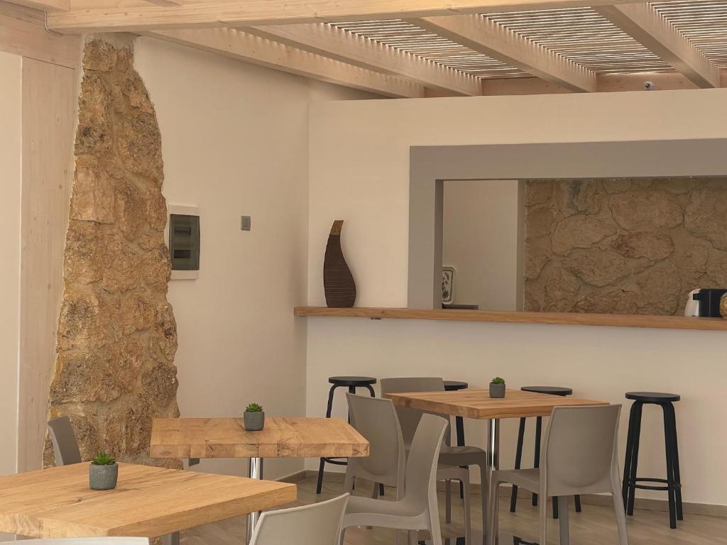 a room with wooden tables and chairs and a mirror at Daedalium in Marina di Palma