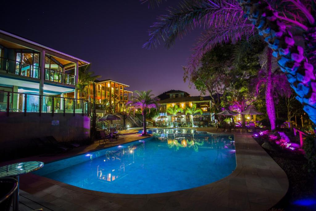 a swimming pool in a resort at night at Eco Resort Serra Imperial in São Pedro da Serra