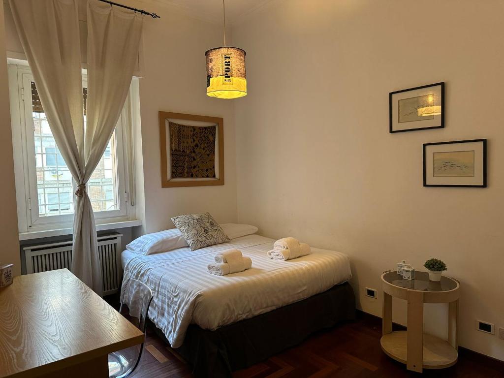 A bed or beds in a room at Porta Latina Apartment