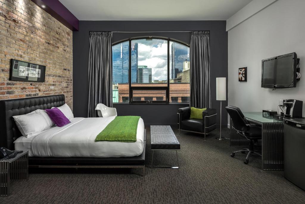 a bedroom with a large bed and a large window at Hotel Metro in London