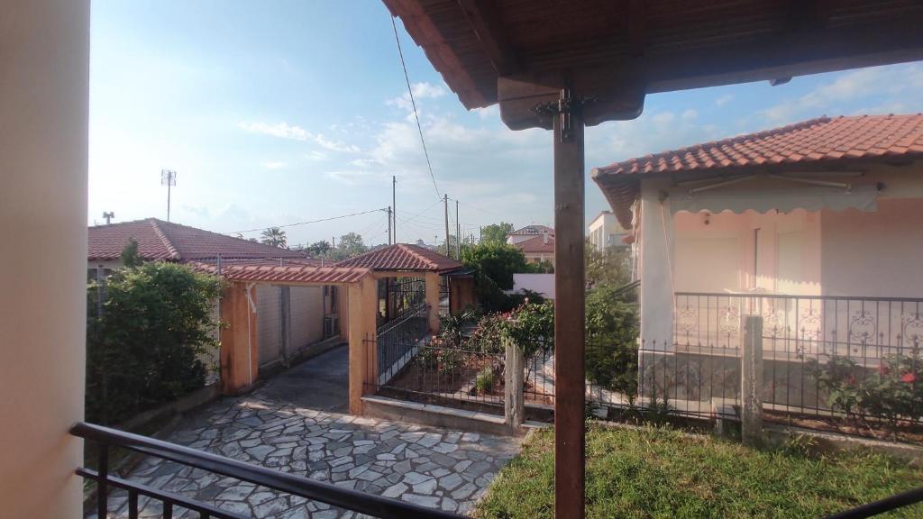 a house with a fence and a gate in a yard at Polis Houses in Nea Iraklia