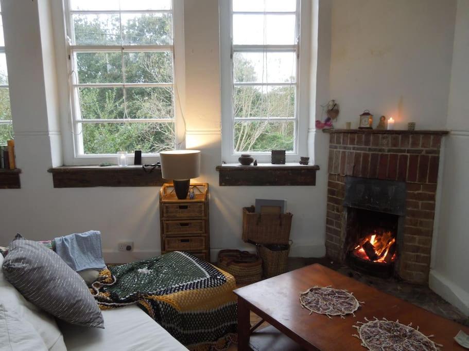 a living room with a fireplace and a couch at Durrus in Durrus