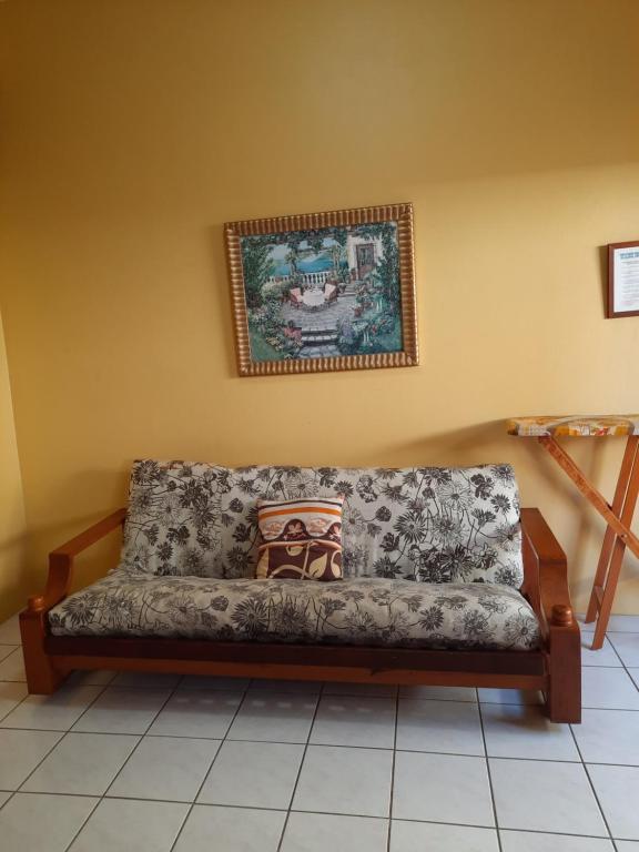 a couch in a room with a picture on the wall at Papa B's Inn in Carnbee Village