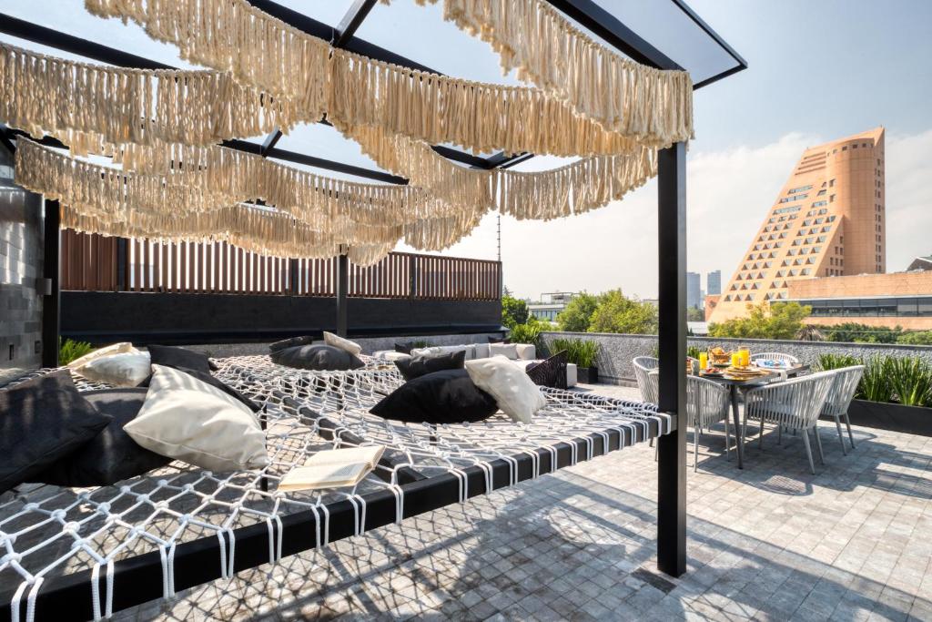 1 cama en un patio con lámparas de araña en ULIV Poe 240 en Ciudad de México