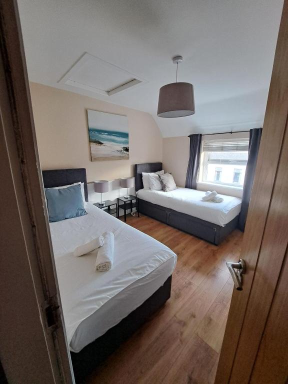 Una habitación de hotel con dos camas y una ventana. en Apt in Stoneybatter D7, en Dublín