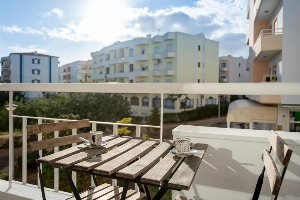 a wooden bench sitting on top of a balcony at Blife Allya private rooms in Faro