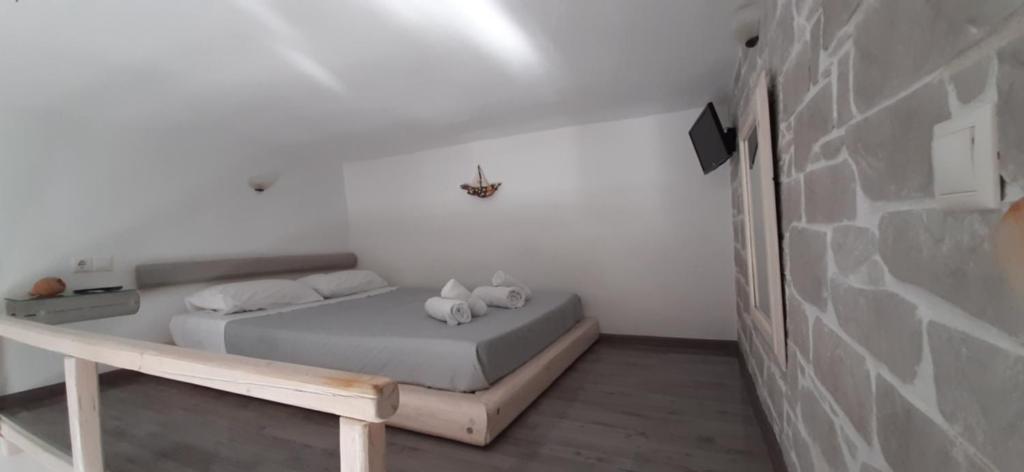 a bedroom with a bed with two stuffed animals on it at Maria's View Delux in Ios Chora