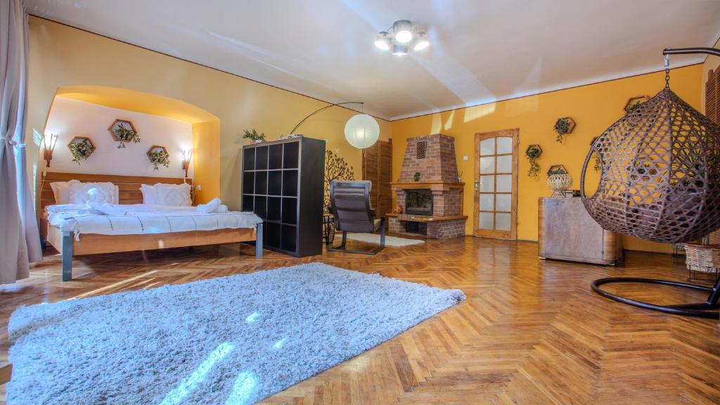 a bedroom with a bed and a blue rug at TREE House-Old Town Brașov in Braşov