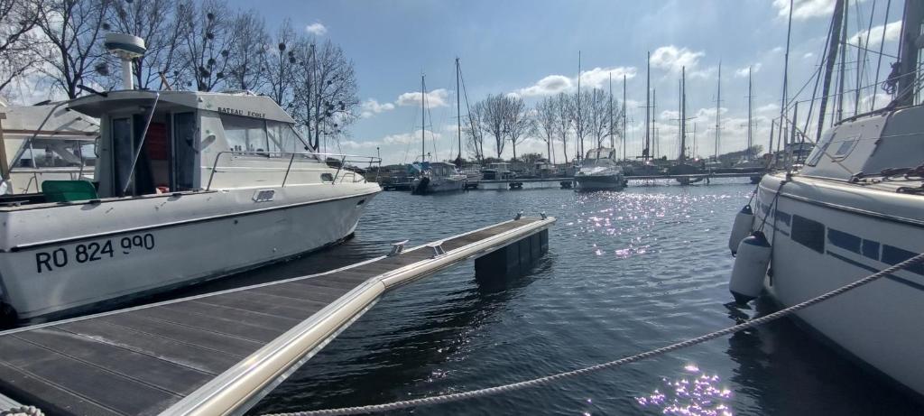 um barco está ancorado numa doca na água em Nuit insolite sur l'eau au port de Ouistreham em Ouistreham