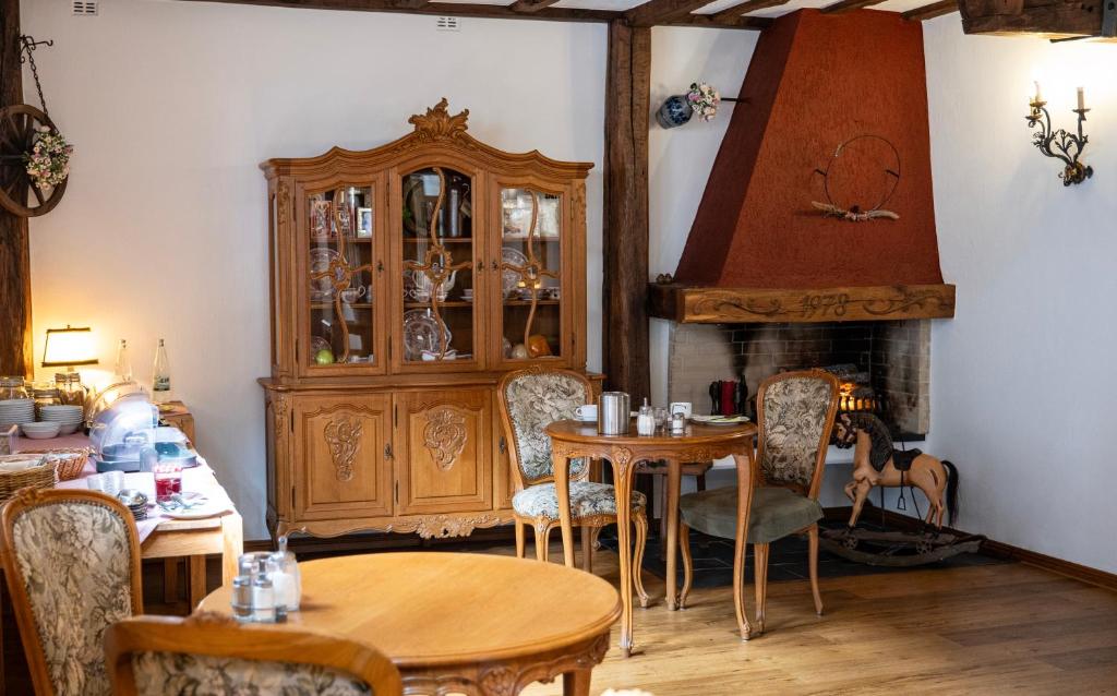 a dining room with a table and a china cabinet at Hotel Royal in Monschau