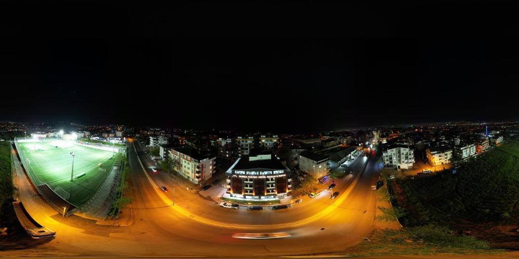 a night view of a city with a street at Vizyon Otel Darıca in Darıca