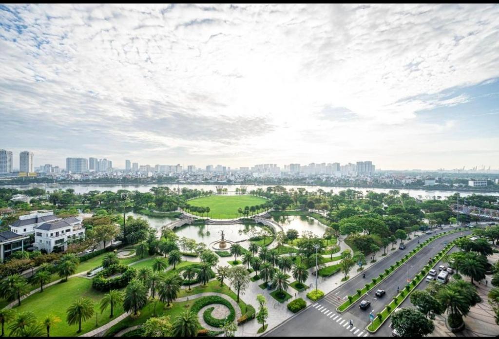 an aerial view of a park with a river and buildings at Vinhome Landmark Suites in Ho Chi Minh City