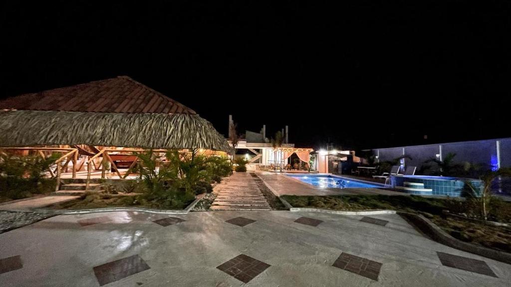 a resort with a swimming pool at night at cabaña vereda linda in Juan de Acosta