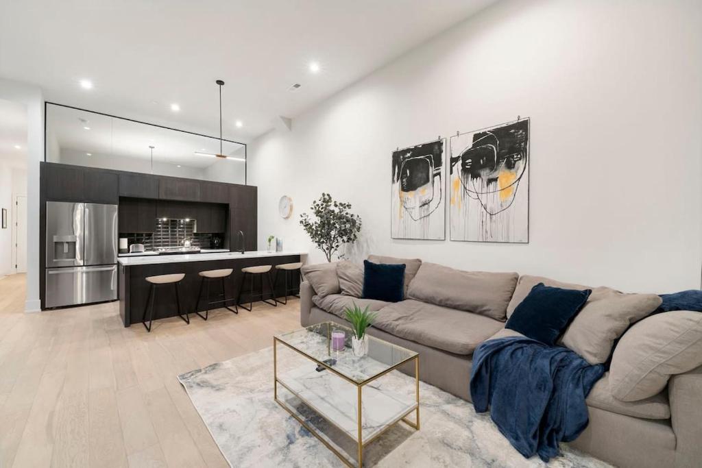 a living room with a couch and a kitchen at Chic River North Condo 2BR 2BA with Private Balcony in Chicago
