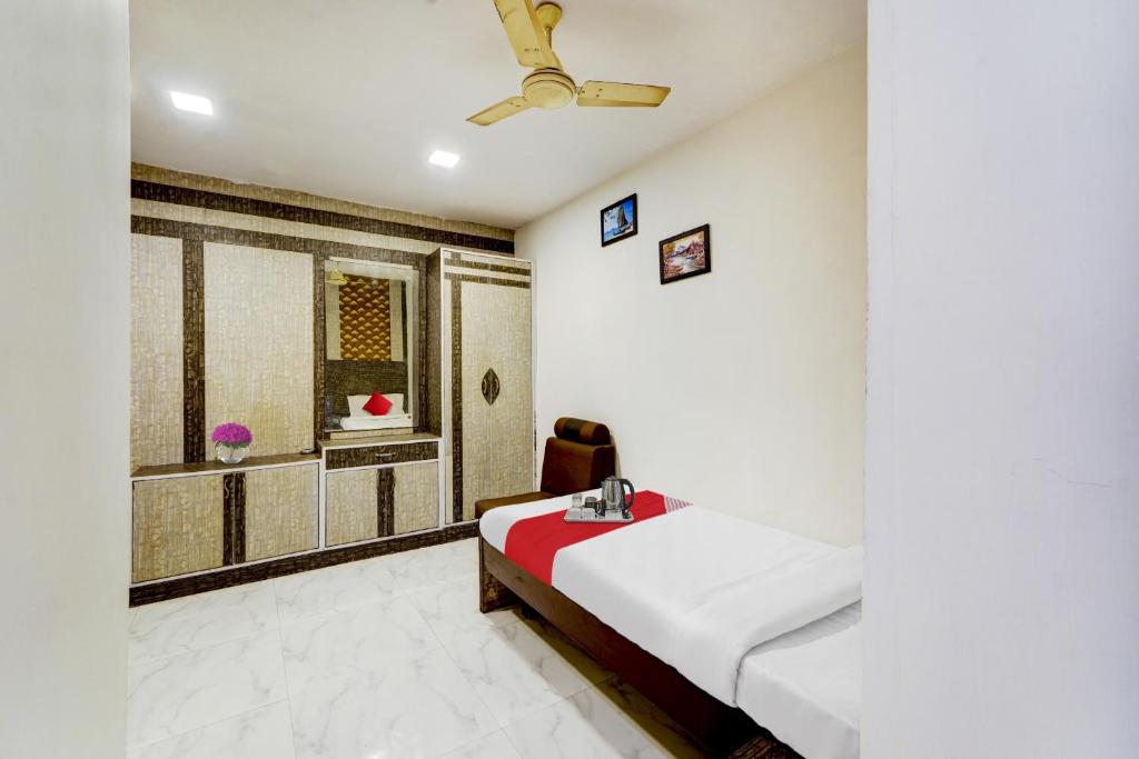 a white room with a bed and a window at OYO Flagship White Inn Near Golden Tower in Chennai