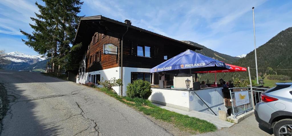 a building with a food stand on the side of a road at Alpinechalet Zigjam in Gaschurn