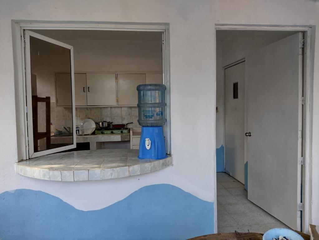 a kitchen with a blue container on a wall at Luz del Mar Bungalos in Sipacate