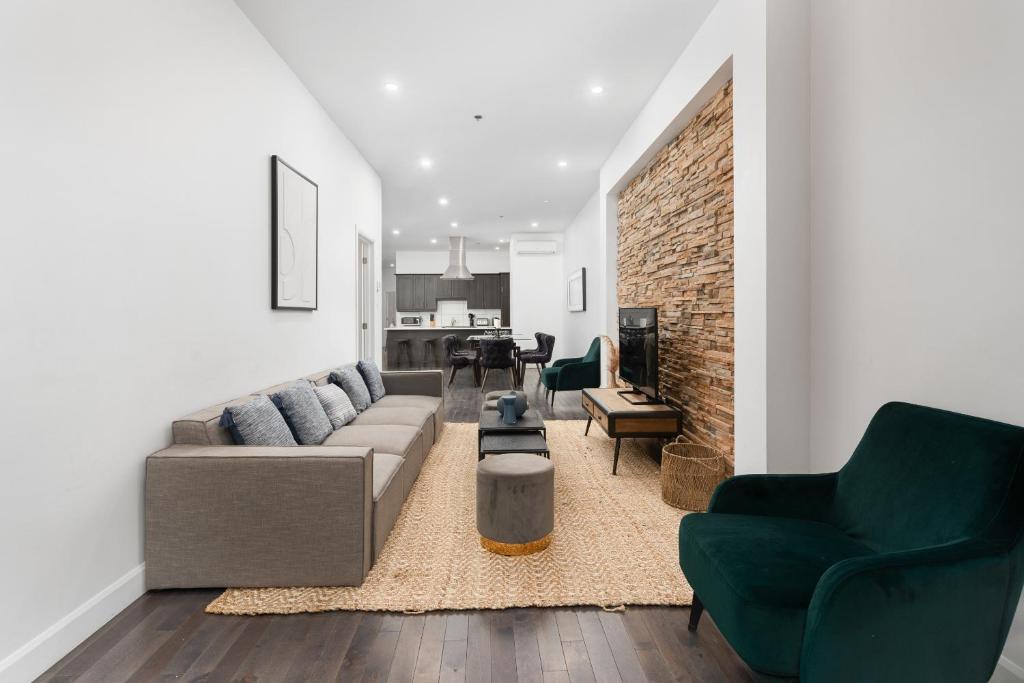 a living room with a couch and two chairs at Boutique Lofts Notre Dame in Montreal