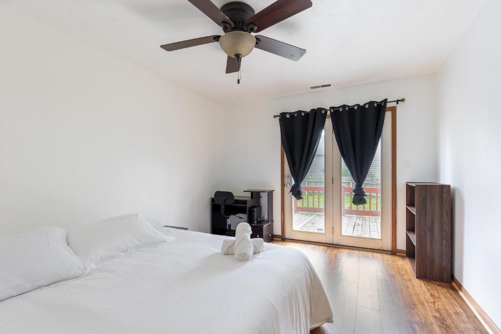 a bedroom with a bed and a ceiling fan at Cozy 3BR Indy Home: Pets, Parking, Family-Ready in Indianapolis