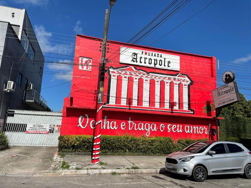 a red building with a sign on the side of it at Pousada ACRÓPOLE in Belém