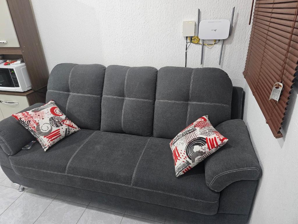 a couch in a room with two pillows on it at RIVERA CASA MIA in San Miguel