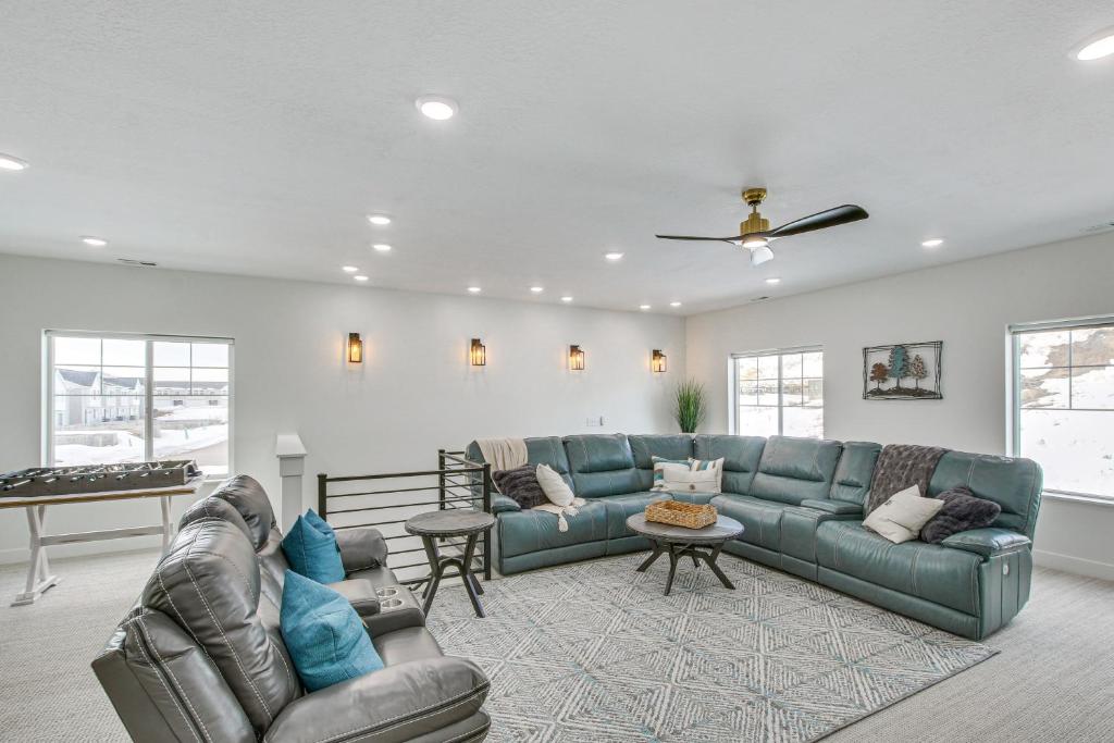 a living room with a couch and a table at Modern and Spacious Garden City Home with Pool Access! in Garden City