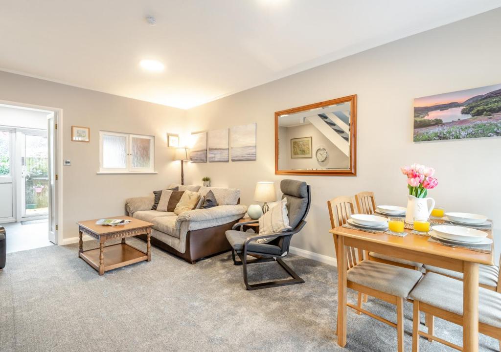 a living room with a couch and a table at Mews Cottage in Grasmere