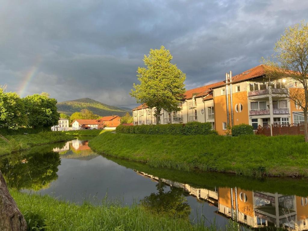 a river in a town with a rainbow in the background at Ferienwohnung für 2 Personen in Bad Kötzting, Bayern in Bad Koetzting