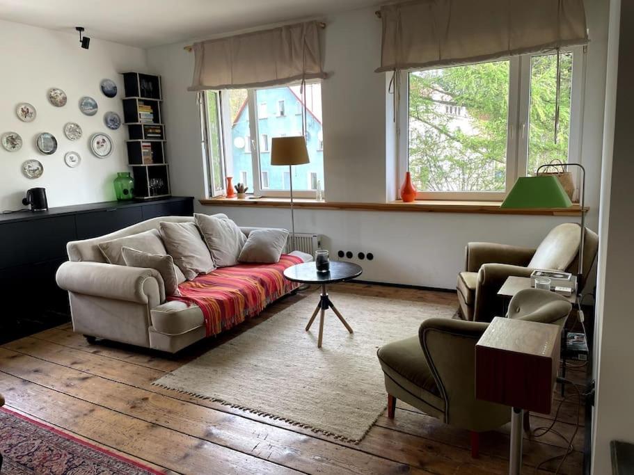 a living room with a couch and two chairs at Pod Modrzewiem in Sokołowsko