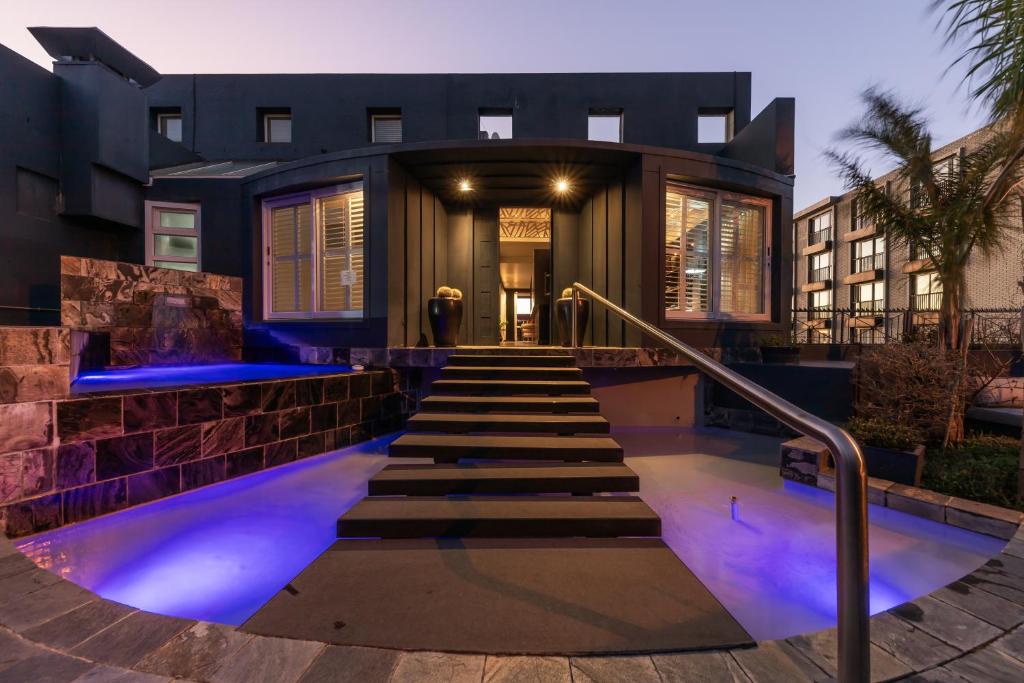 a house with blue lights on the stairs at O on Kloof Boutique Hotel & Spa in Cape Town