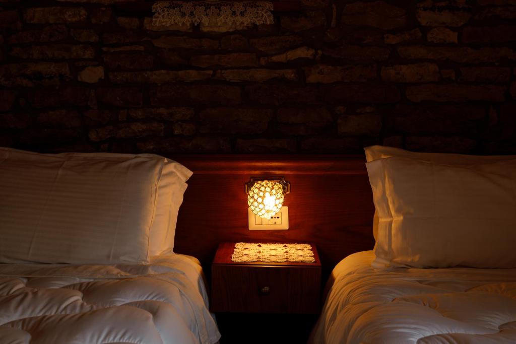Postel nebo postele na pokoji v ubytování Hotel Pashai