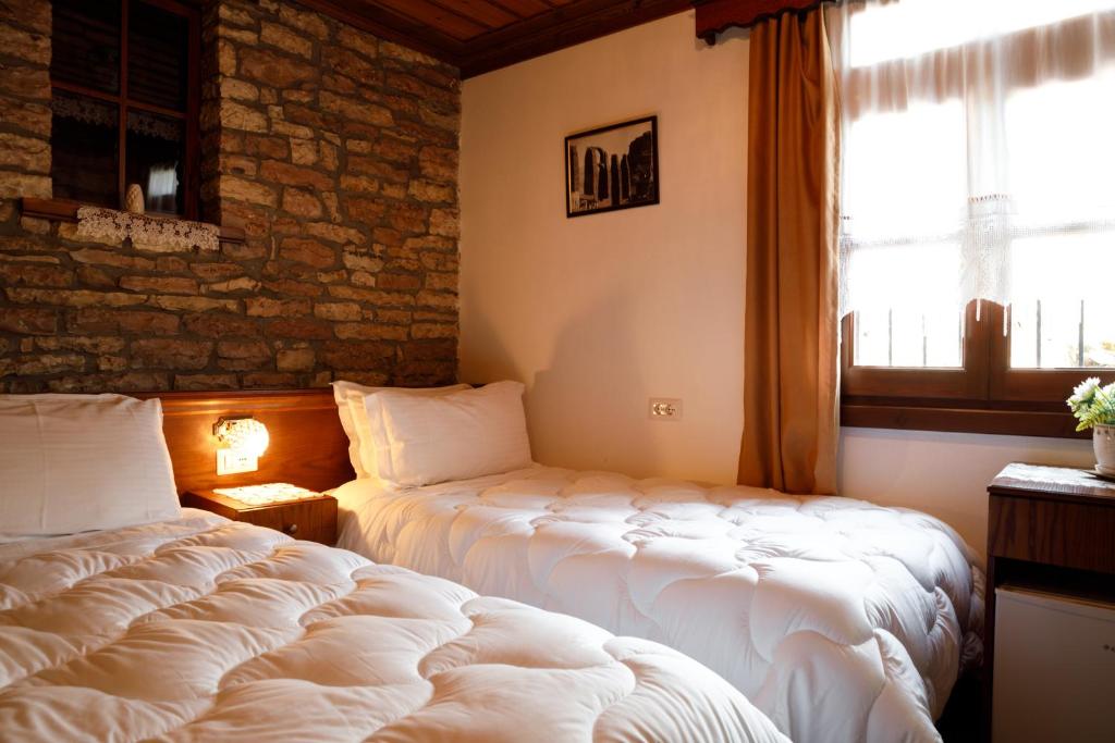 Postel nebo postele na pokoji v ubytování Hotel Pashai