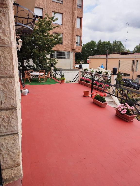 a red brick patio with potted plants and a building at Casa Ereño in Medina de Pomar