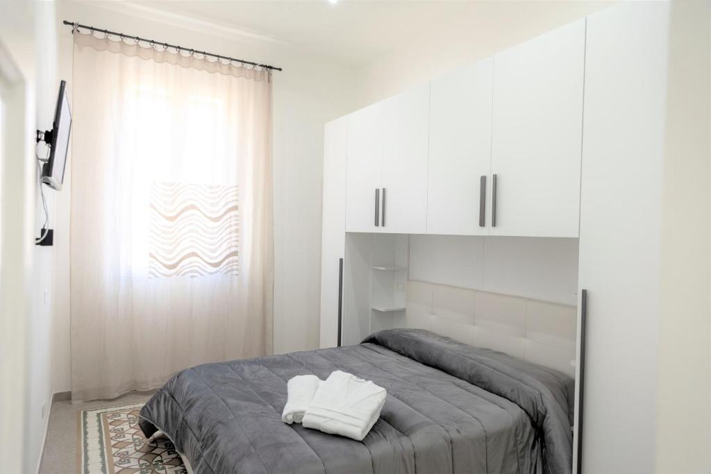 a bedroom with a bed with two pillows on it at Casa Vacanze Altea in Santa Flavia