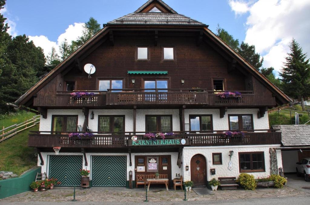 a large wooden house with a balcony at Wohnung mit Balkon und toller Aussicht in Falkertsee
