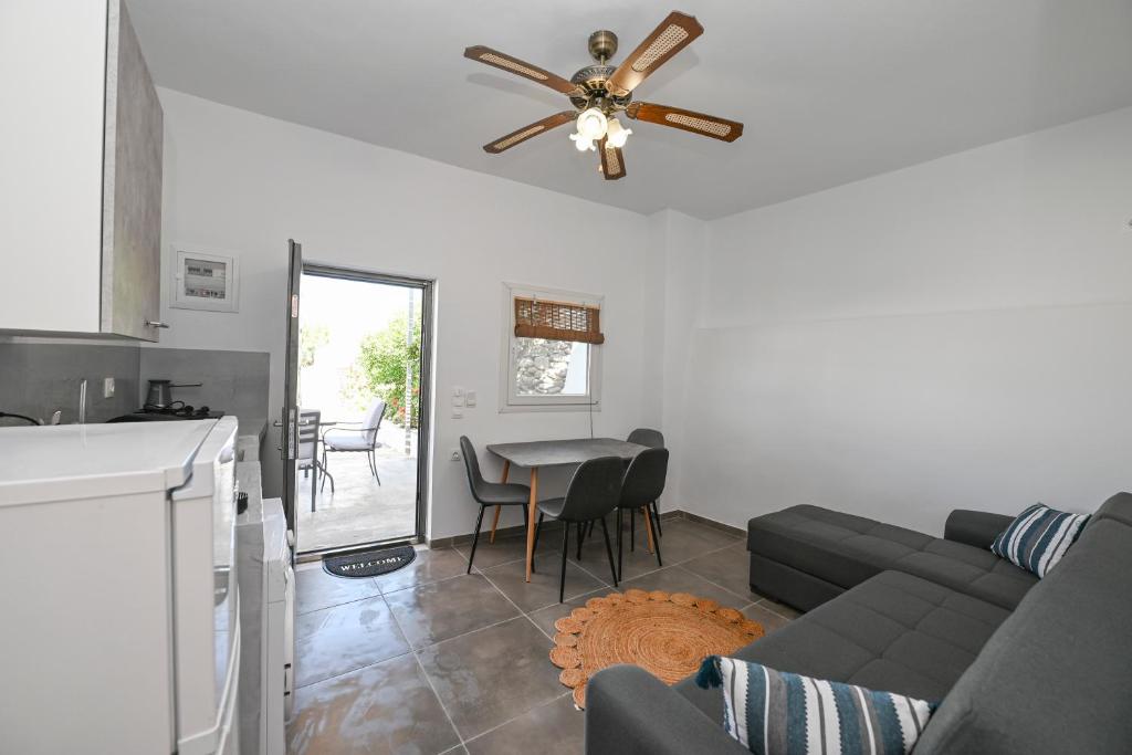 a living room with a couch and a ceiling fan at kleris apartment 11 in Tinos Town