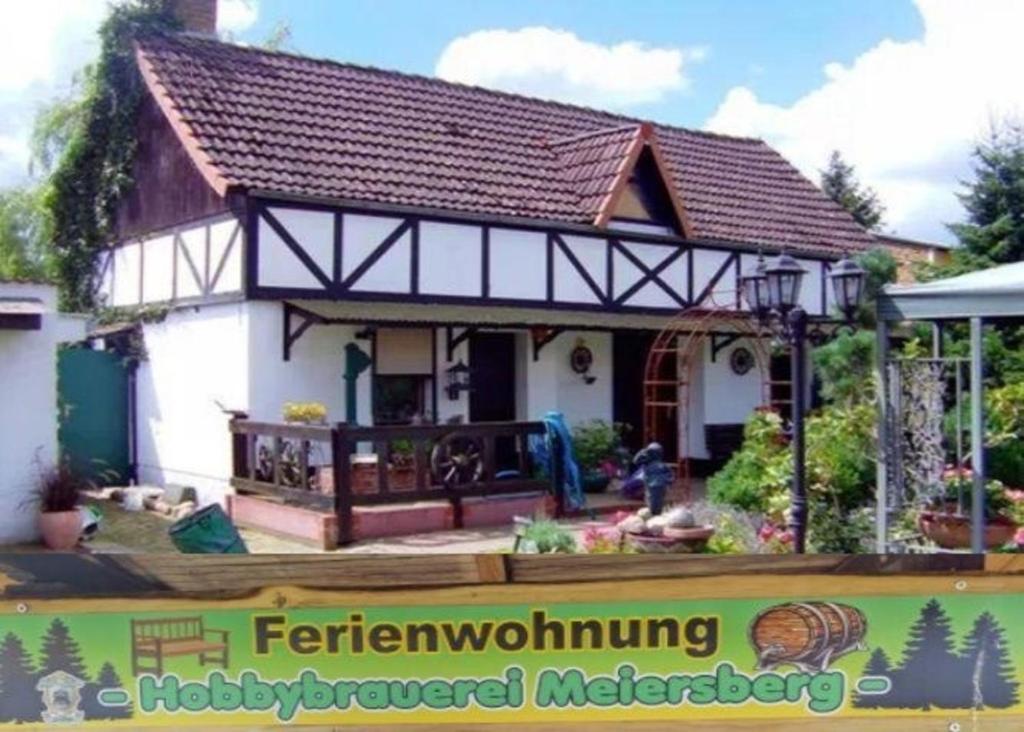 a small white house with a brown roof at Appartement in Meiersberg mit Grill, Terrasse und Garten - b48747 in Grambin