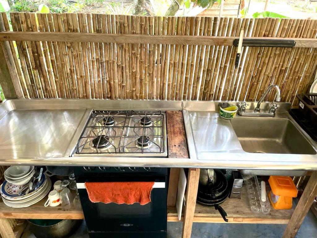 a kitchen with a sink and a stove at Casa Alma in Capurganá