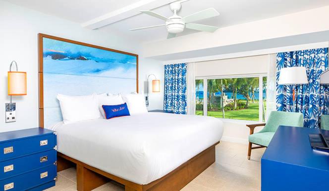a bedroom with a large white bed and a window at Caribbean Life in St. Thomas in Bolongo