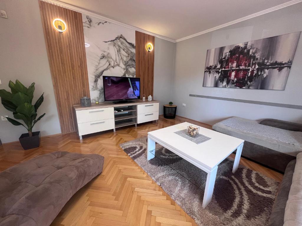 a living room with a couch and a table at Apartment Ortakovski in Skopje