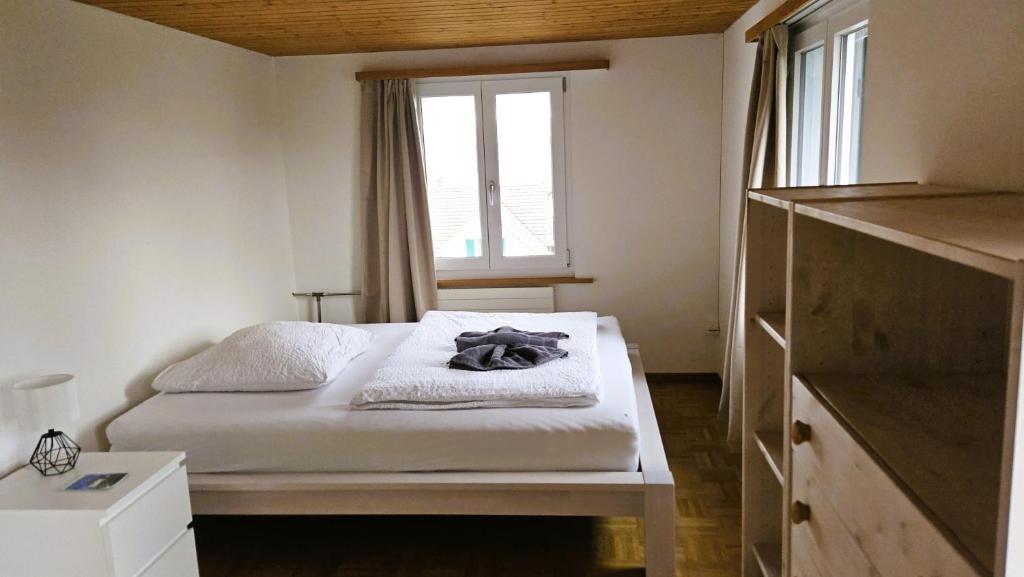 a small bedroom with a bed and a window at MBar Apartment in Altnau