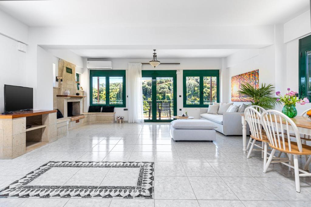 a living room with a couch and a table at Villa Giannari in Stalos
