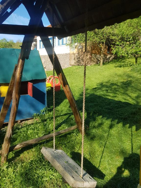 a playground with a swing in a yard at La Casiru guesthouse in Straja