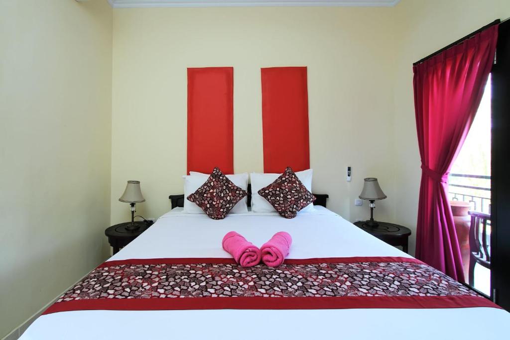 Postel nebo postele na pokoji v ubytování Ramantika Bali House