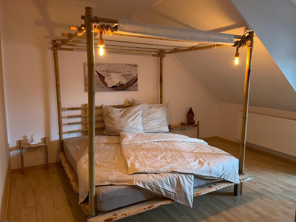 a bedroom with a canopy bed in a attic at Bambus, Jungle, Dachterrasse & bequem bis Zentrum in Radebeul